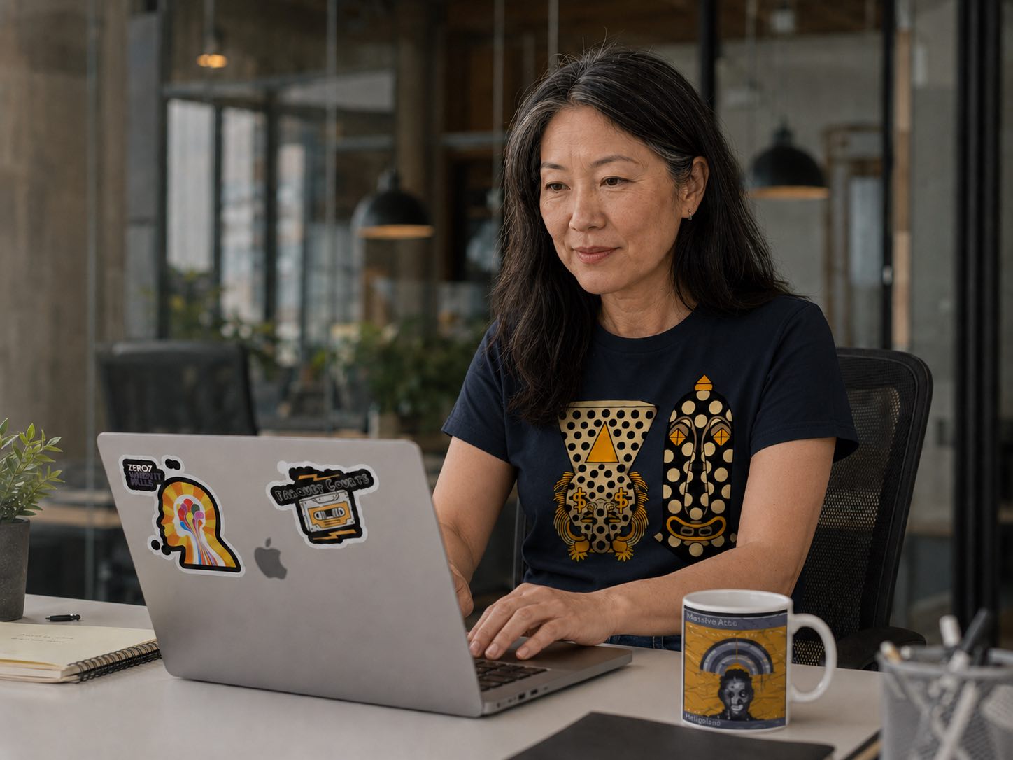 A music fan wearing and using Earbug artist merch, including a t-shirt, stickers, and a mug